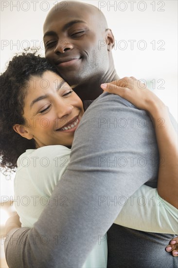 Close up of smiling couple hugging