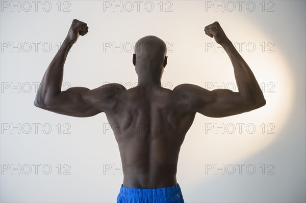 Black man flexing muscles