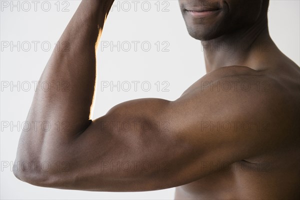 Black man flexing muscles