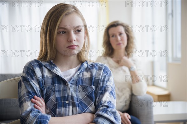 Caucasian mother and daughter arguing in living room