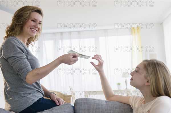 Caucasian mother giving daughter money