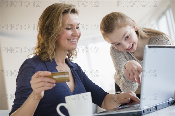 Caucasian mother and daughter shopping online