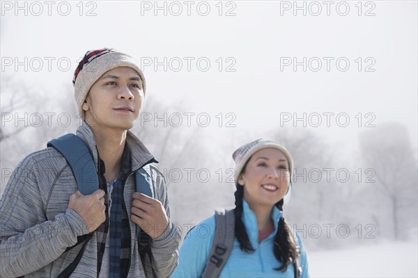 Couple hiking in snowy field