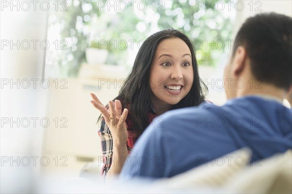 Couple talking on sofa in living room