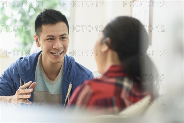Couple talking on sofa in living room