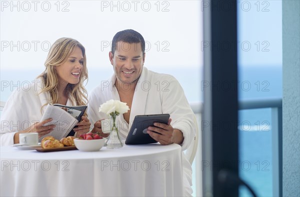 Couple enjoying breakfast on balcony