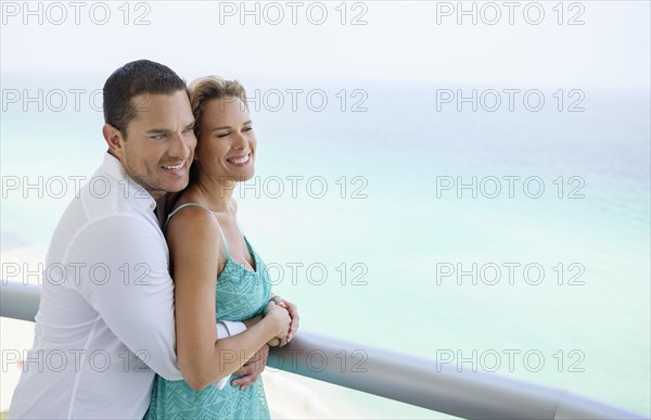 Couple hugging on balcony