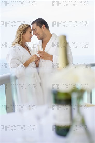 Couple drinking champagne on balcony table