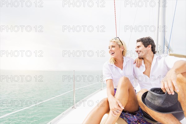 Couple hugging on deck of sailboat