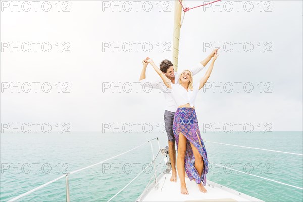Couple dancing on deck of sailboat