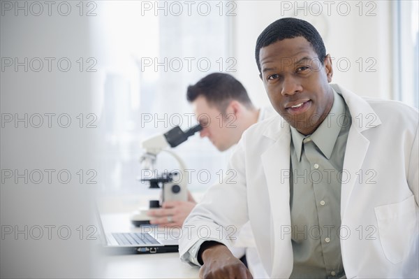 Scientist sitting at table in lab