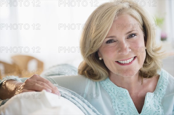 Caucasian woman smiling on sofa