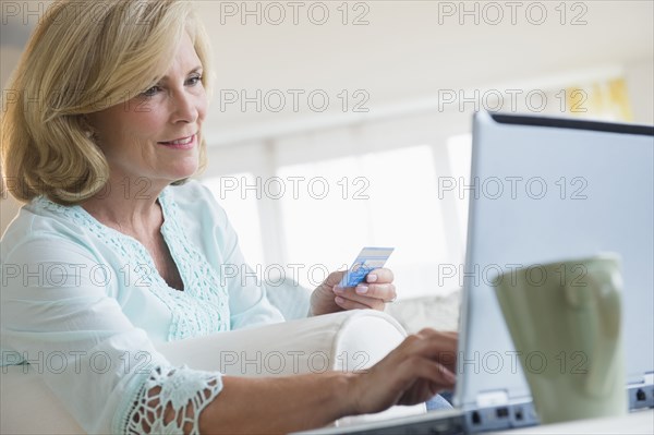 Caucasian woman shopping online with laptop
