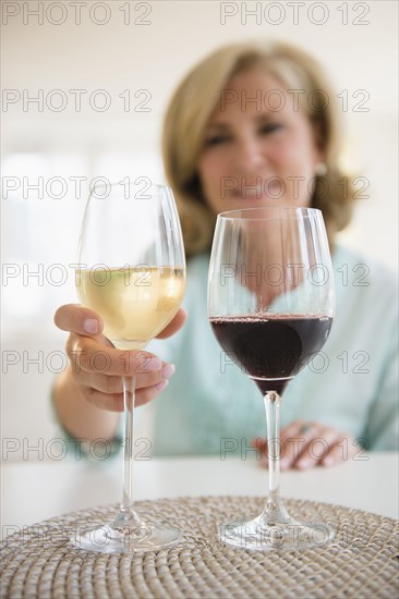 Caucasian woman choosing white wine and red wine