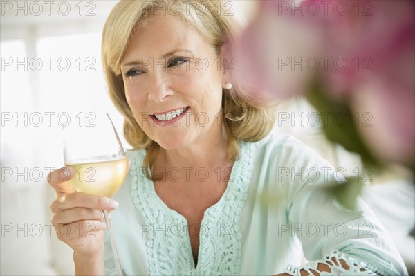 Caucasian woman drinking white wine