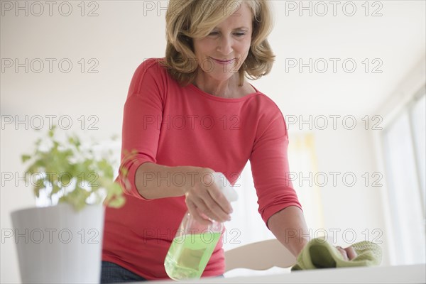Caucasian woman cleaning table