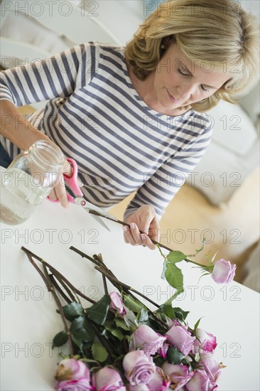 Caucasian woman trimming flowers