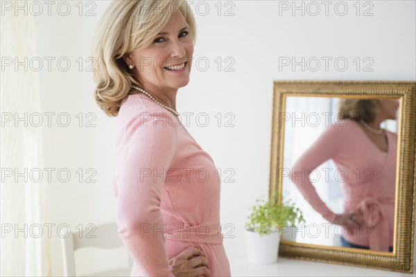 Caucasian woman smiling in mirror