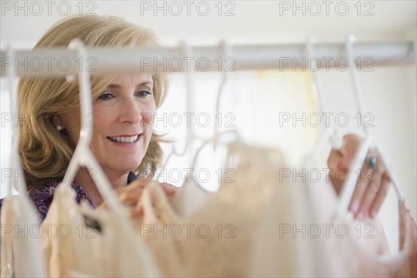 Caucasian woman shopping in clothing store