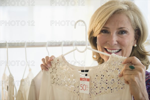 Caucasian woman shopping in clothing store