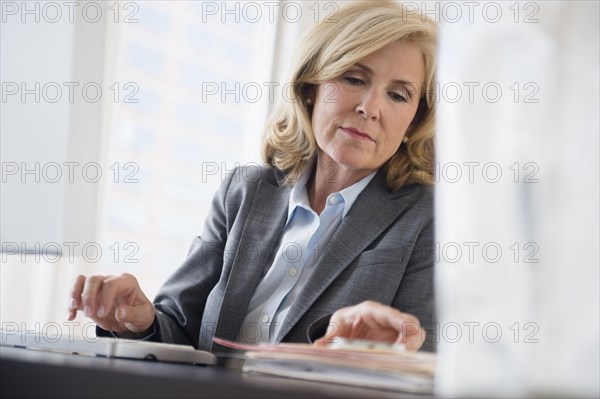 Caucasian businesswoman working in office