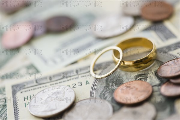 Close up of wedding rings with money