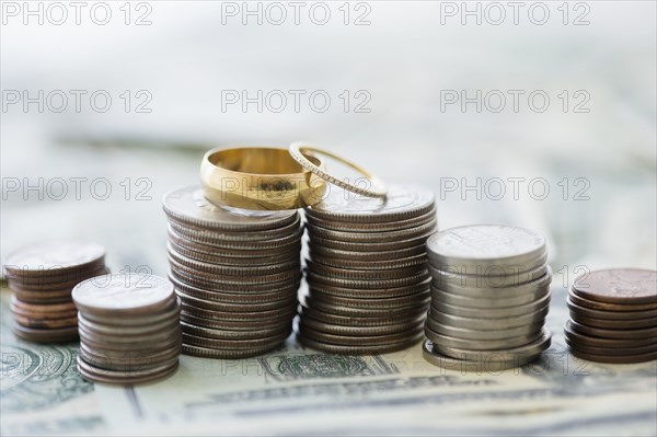 Close up of stacks of coins and wedding rings