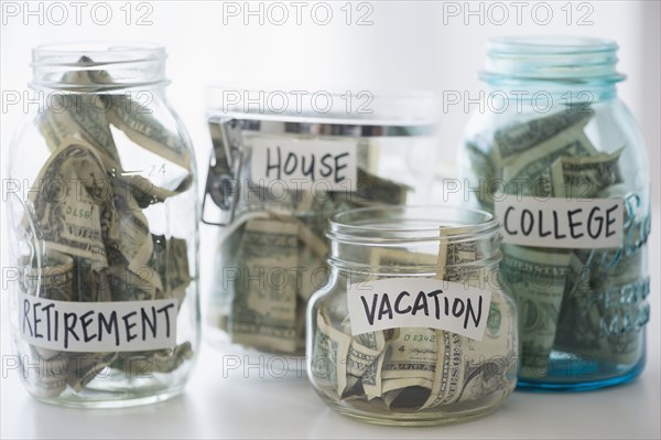 Close up of savings jars with money