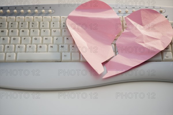 Close up of broken heart on computer keyboard