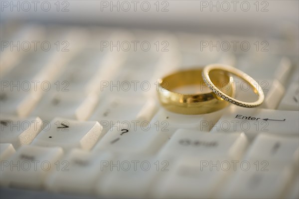Close up of wedding rings on computer keyboard