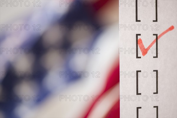 Close up of voting ballot near American flag