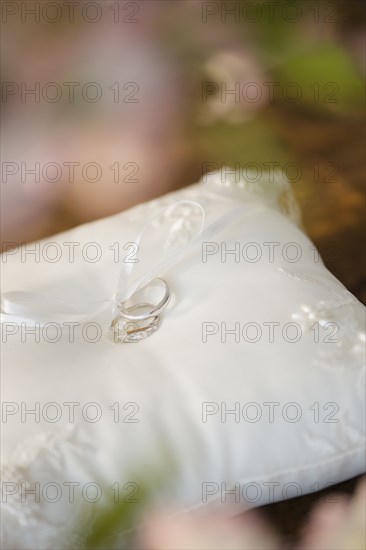 Close up of wedding rings on ring pillow