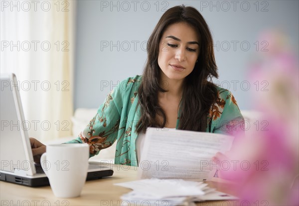 Woman paying bills on laptop