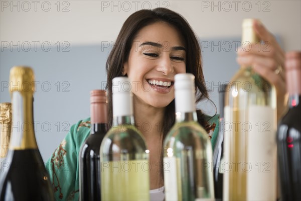 Woman choosing bottle of wine