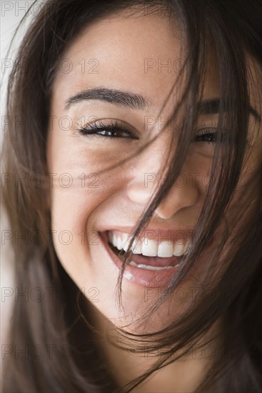 Close up of laughing woman with messy hair