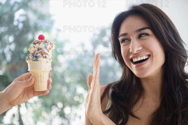 Woman refusing ice cream cone