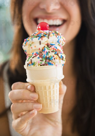 Close up of woman holding ice cream cone