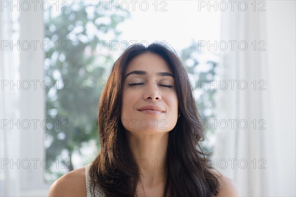 Calm woman breathing with eyes closed