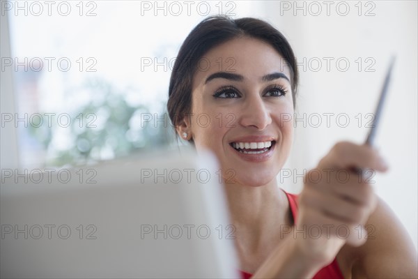 Businesswoman gesturing with pen