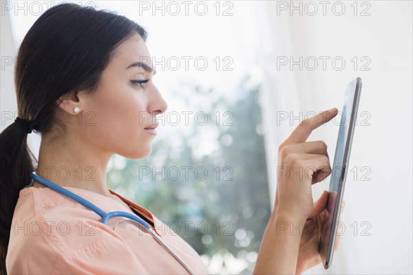 Nurse using digital tablet in hospital