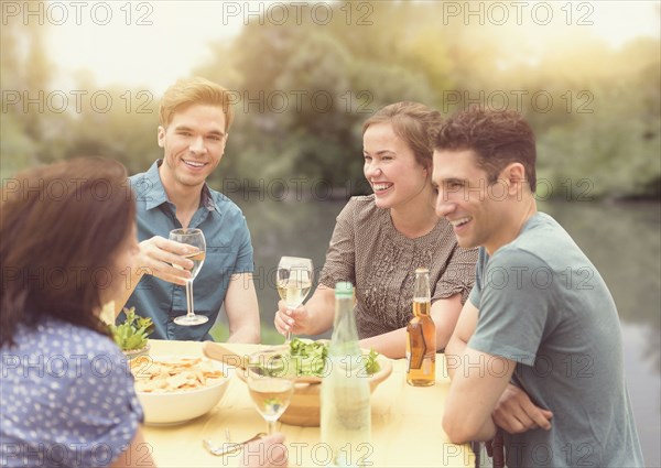 Friends having dinner party in backyard