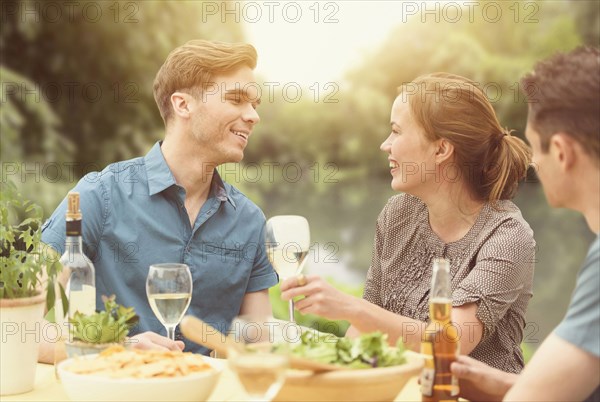 Friends having dinner party in backyard