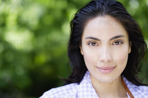 Close up of Hispanic woman smiling outdoors