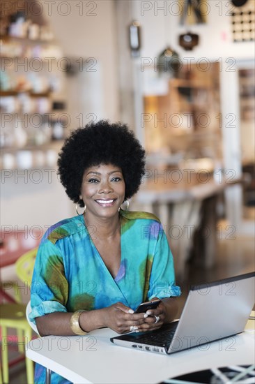 African American business owner using laptop in store