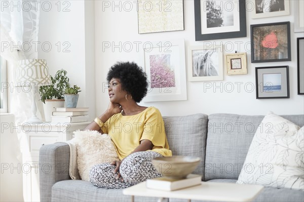 African American woman relaxing on sofa