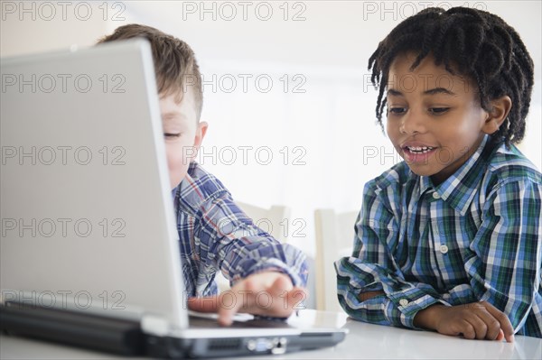 Close up of boys using laptop at desk