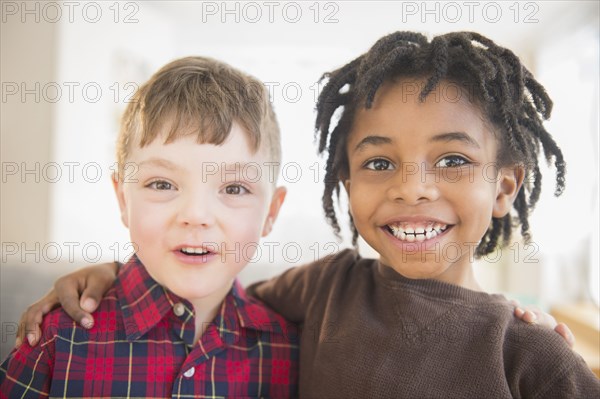 Close up of smiling boys hugging