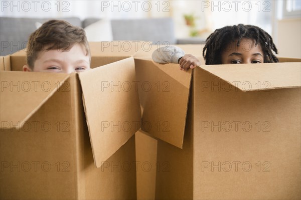 Close up of boys playing in cardboard boxes