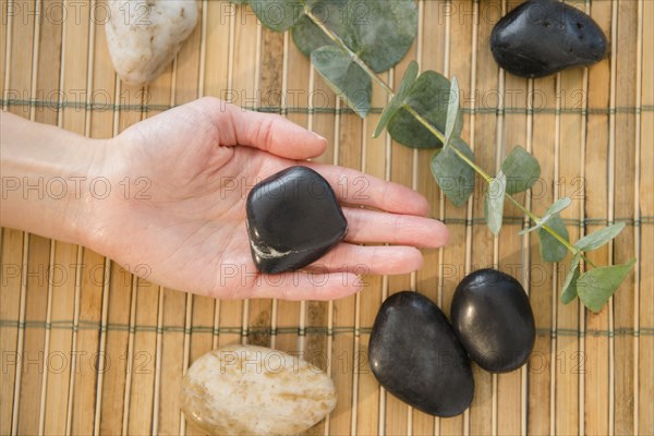 Mixed race woman holding massage stones