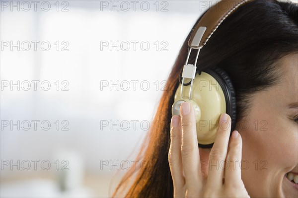 Mixed race woman listening to headphones